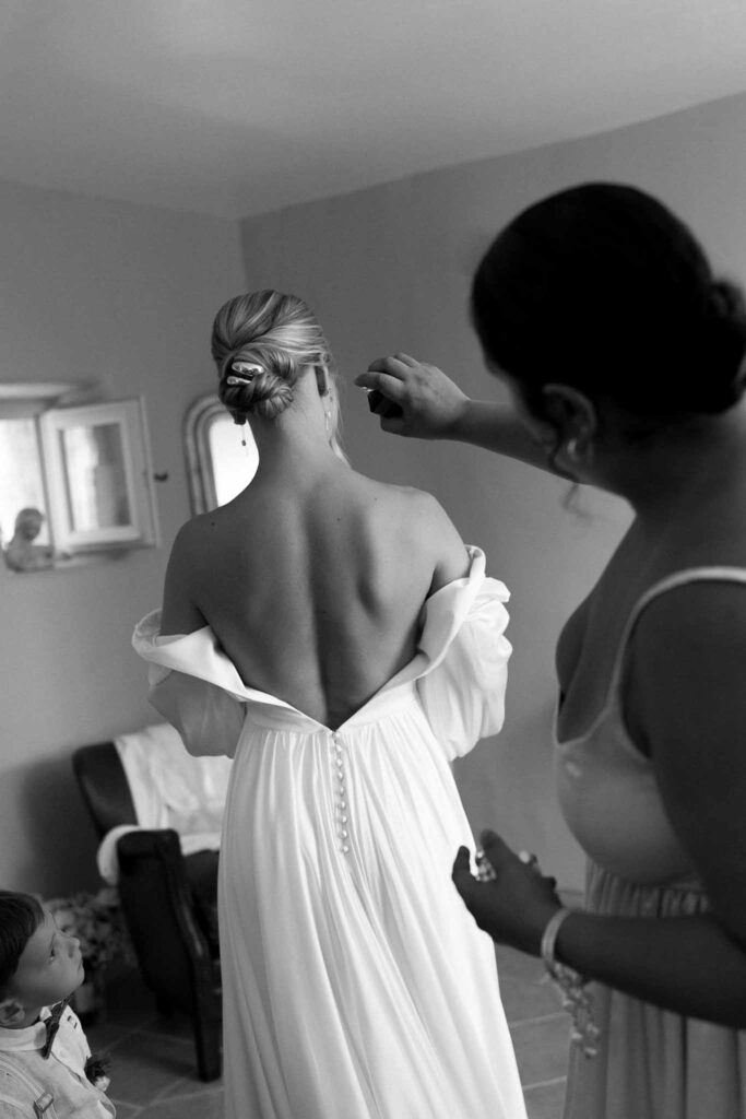 Clos d Hullias Ozaria flatlay bride getting ready open back dress spray black white photo