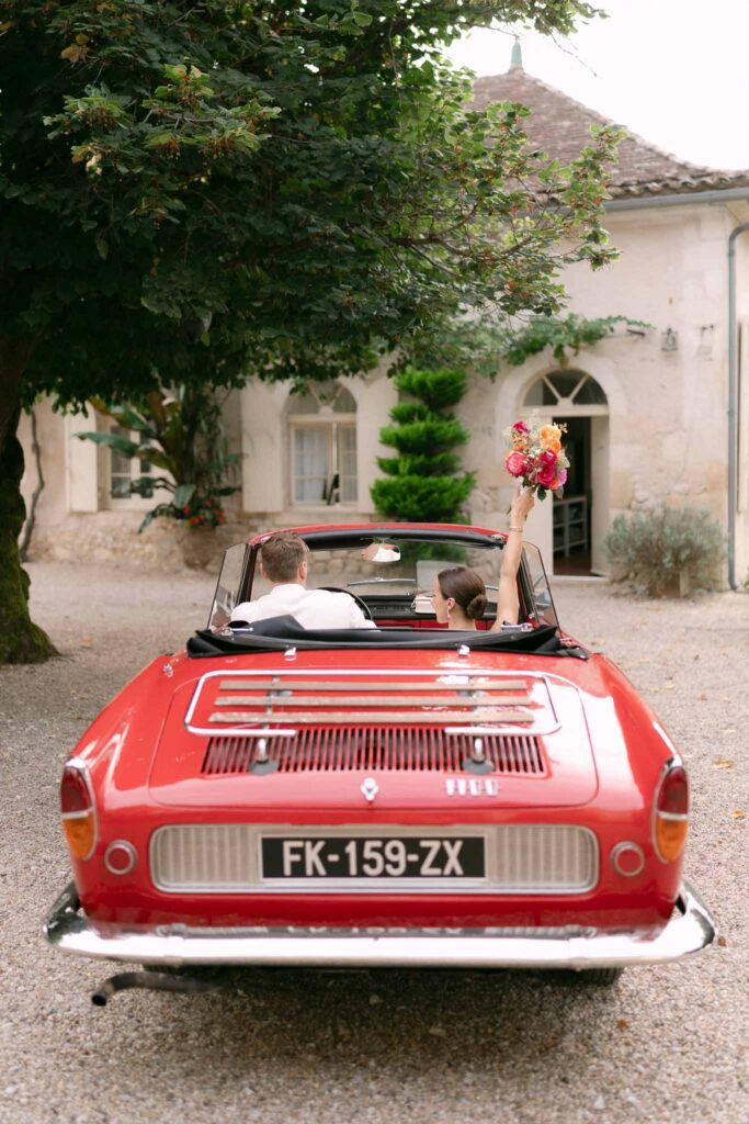 red vintage car bride and groom bouquet tossing 