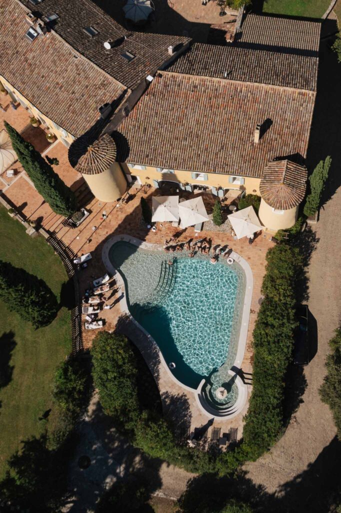 lesCrostes Ingrid aerial shot venue brick roof old vintage building pool