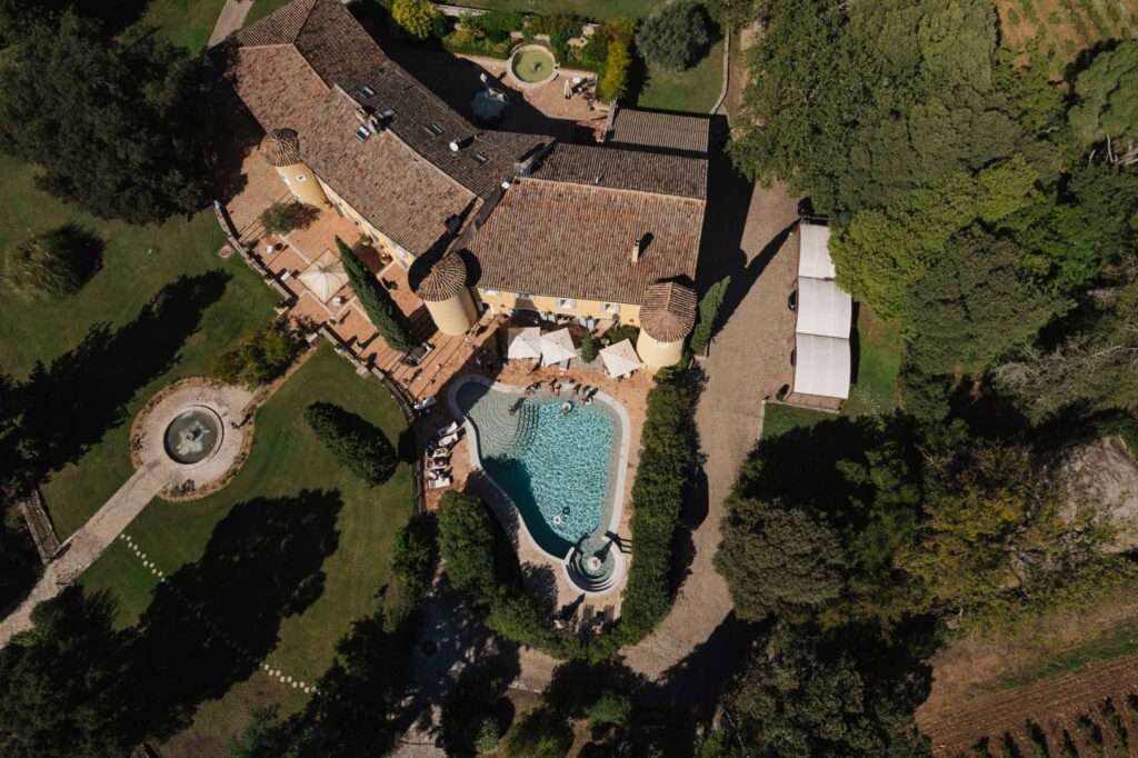 lesCrostes Ingrid aerial shot venue brick roof old vintage building pool fountain