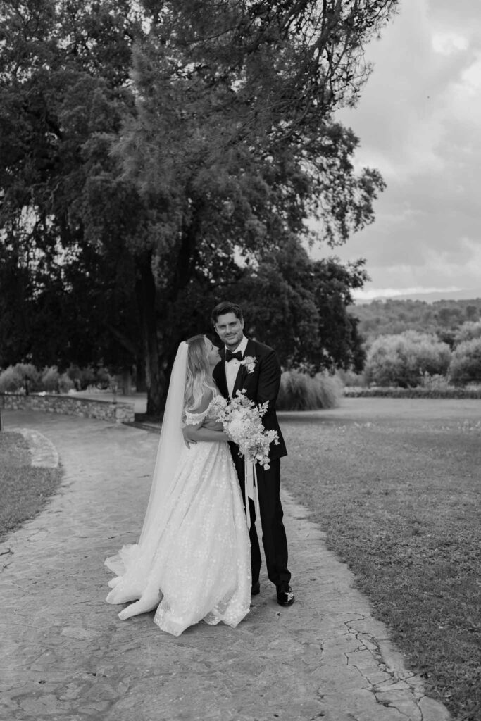 lesCrostes Ingrid bride looking groom hugging black white photo