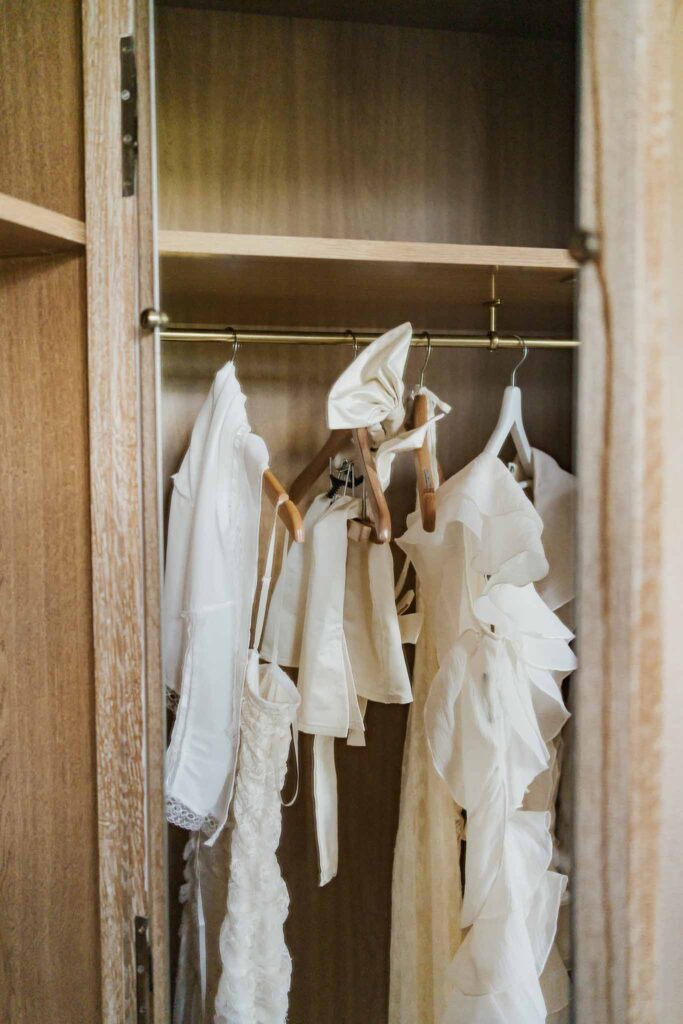 lesCrostes Ingrid white dresses hanging inside wood cabinet