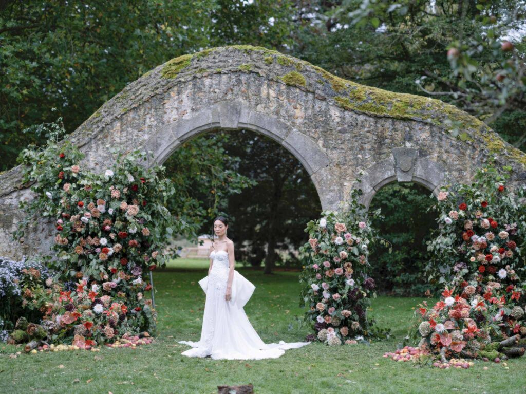 wedding editorial at Manoir de Vacheresses Dogwood Fir bride standing flower designs old structure background