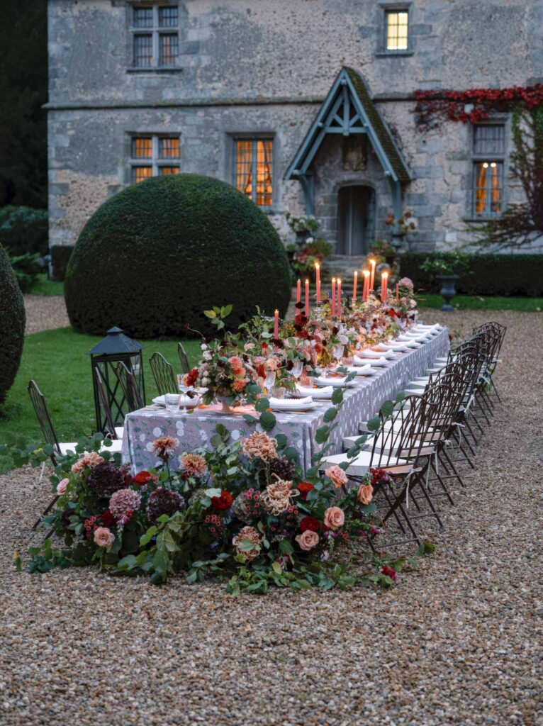 wedding editorial at Manoir de Vacheresses long reception table dark color flower decor