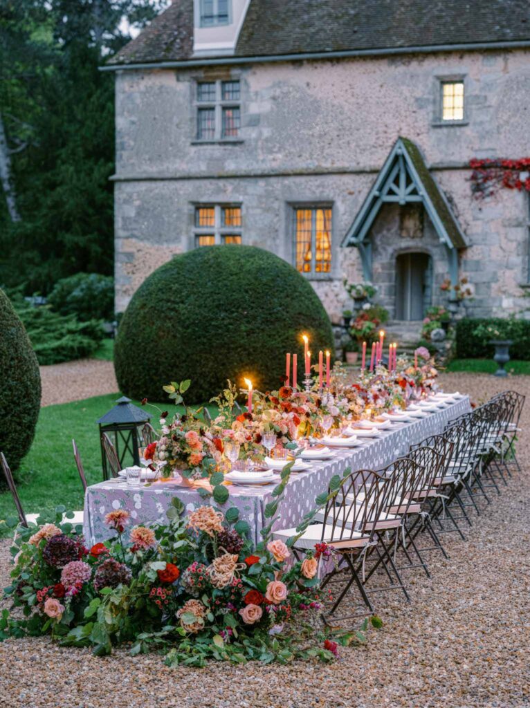 Manoir de Vacheresse Capucine reception table metal chairs dark flowers candles old house garden